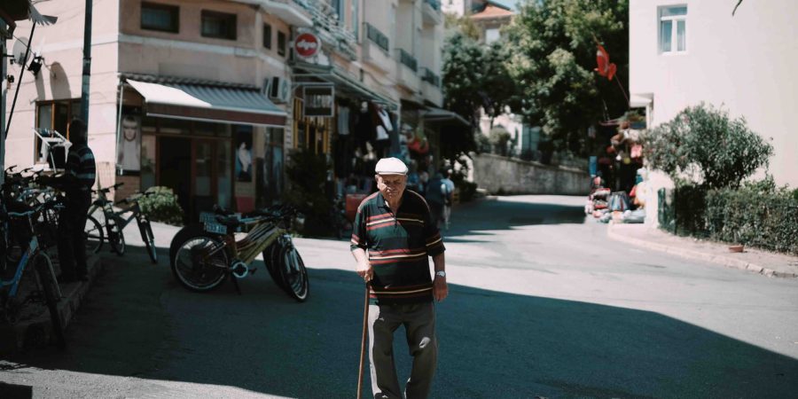 Old Man Walking Down Street