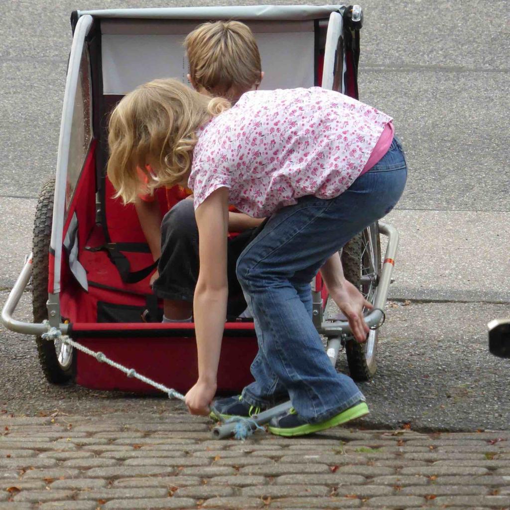 Children playing with bike trailer